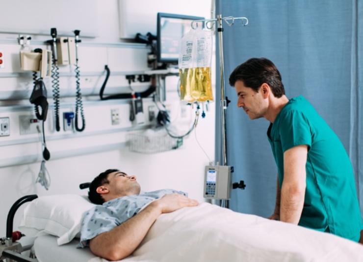 Patient in bed talking to nurse